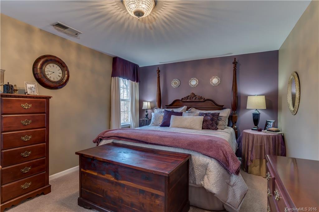 110 Bechtler Court Rutherfordton, NC 28139 - Photo 16 of 24 a bedroom with a bed and a chandelier