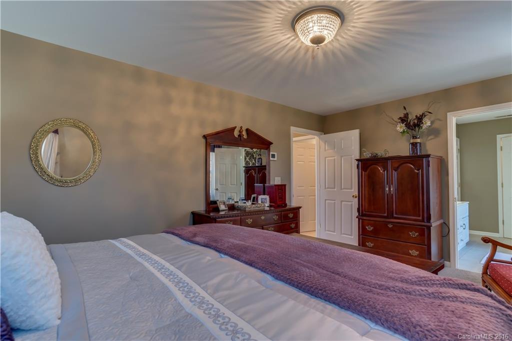 110 Bechtler Court Rutherfordton, NC 28139 - Photo 17 of 24 a bedroom with a bed and a chandelier