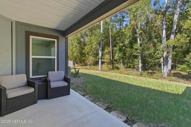 a view of a backyard with sitting area