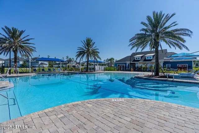 a view of a house with swimming pool and a yard