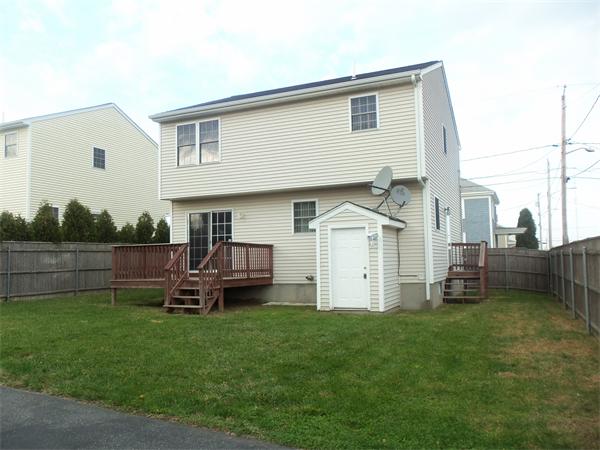 85 Baird Street Fall River, MA 02721 - Photo 8 of 8 a front view of a house with a garden and chairs