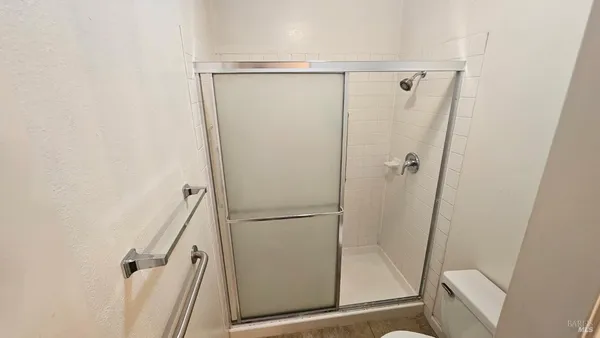 a bathroom with a glass door shower