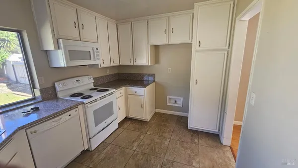 a kitchen with a stove sink and a refrigerator