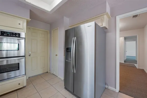 a kitchen with stainless steel appliances a refrigerator and a stove top oven