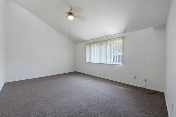 an empty room with a empty space and windows