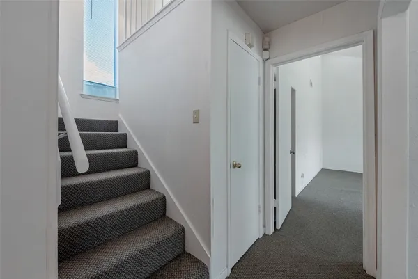 a hallway with couch and a bookshelf