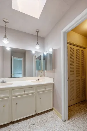 a bathroom with a double vanity sink and mirror