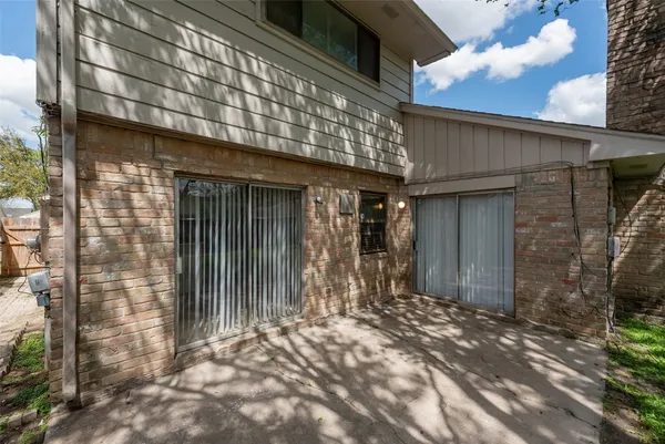 a view of house with entrance door and an outdoor space