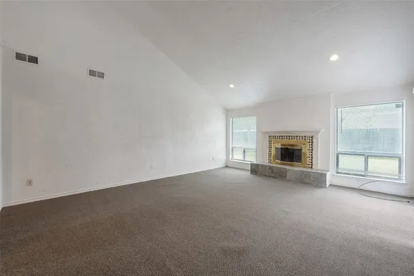 a view of empty room with a fireplace
