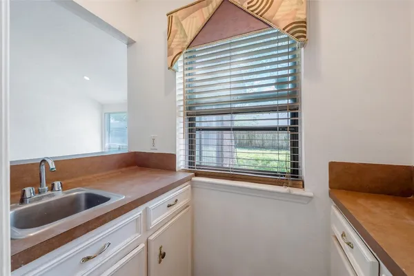 a kitchen with a sink and a window