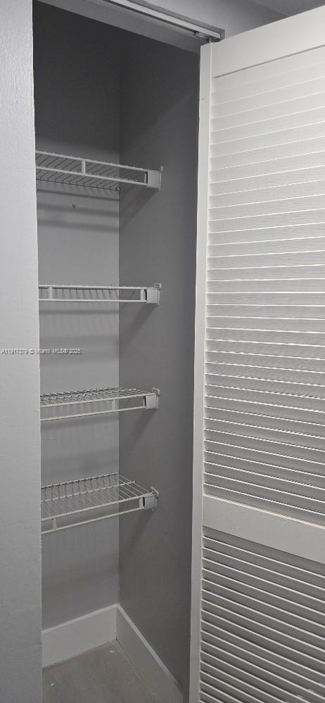 8145 Northwest 7th Street, Unit 320 Miami, FL 33126 - Photo 4 of 9 a view of a room with shelves