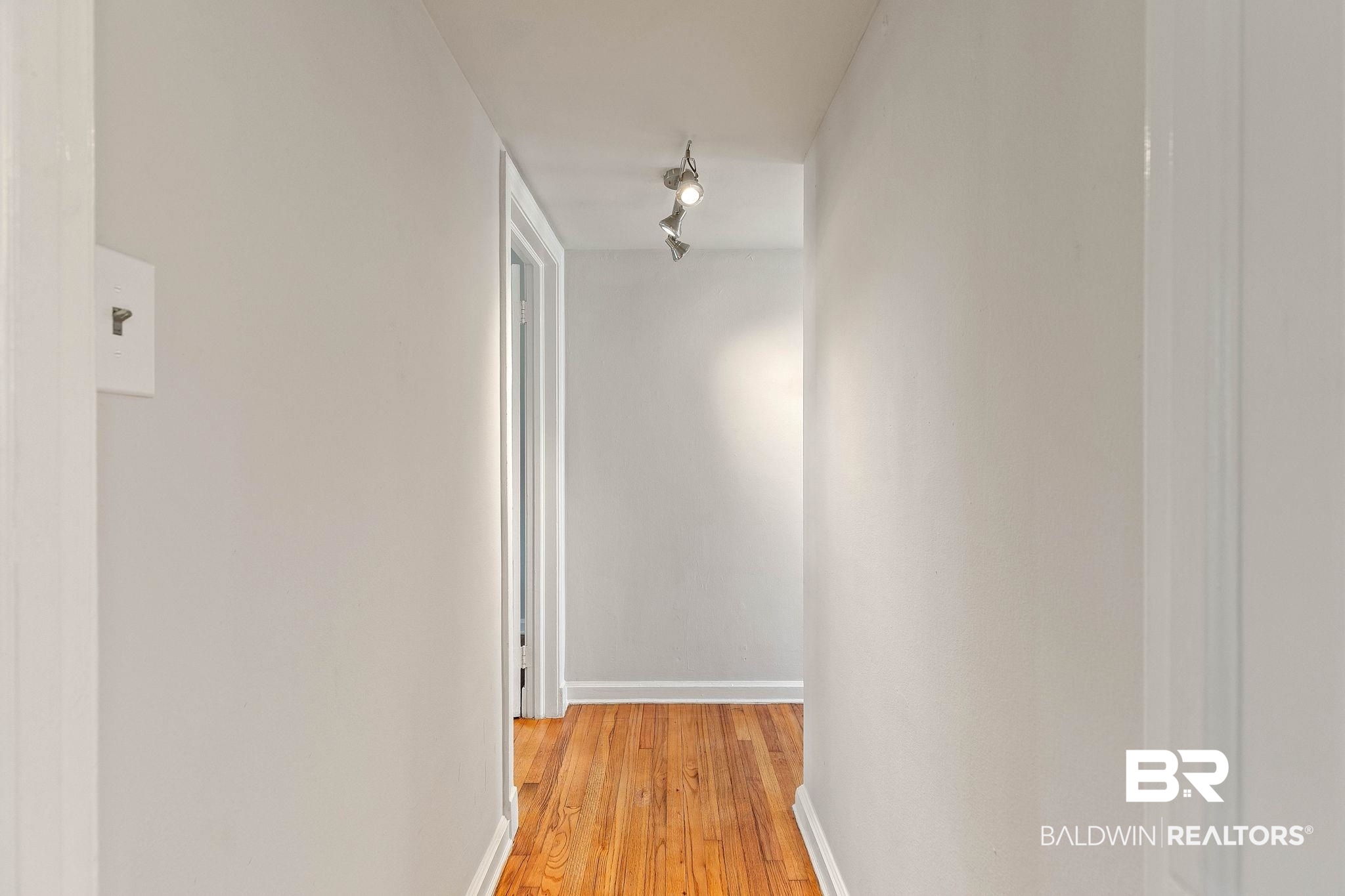 214 Upham Street, Unit 8D Mobile, AL 36607 - Photo 19 of 36 Hall featuring baseboards and light wood-style flooring