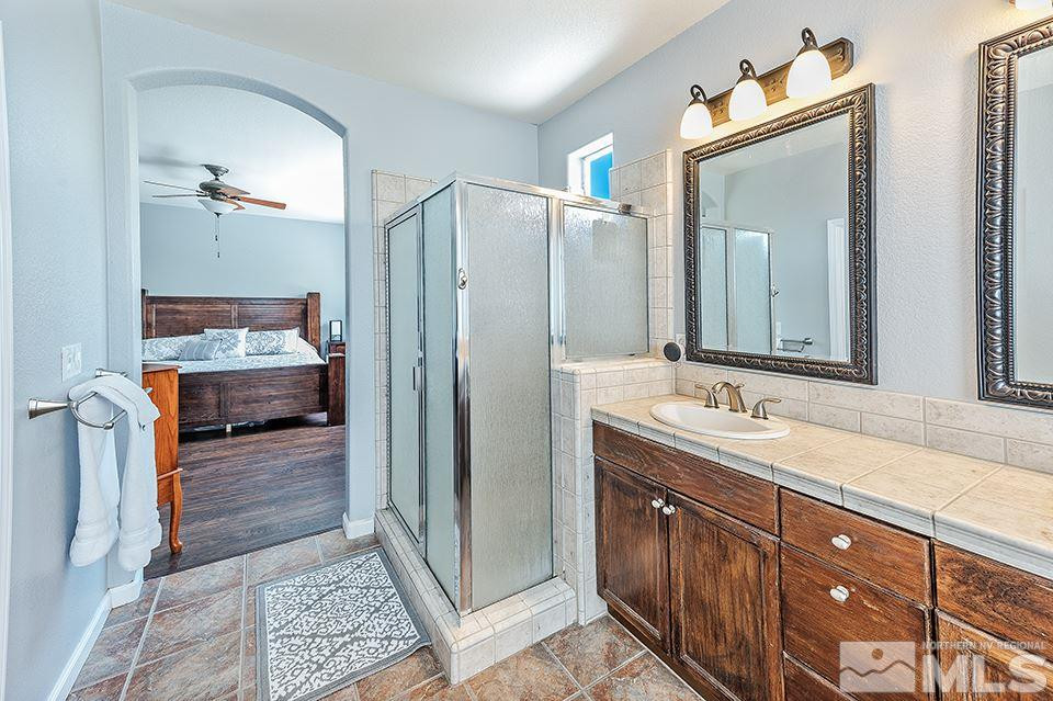 1783 Back Country Road Reno, NV 89521 - Photo 11 of 16 a en suite bathroom with a sink and a mirror