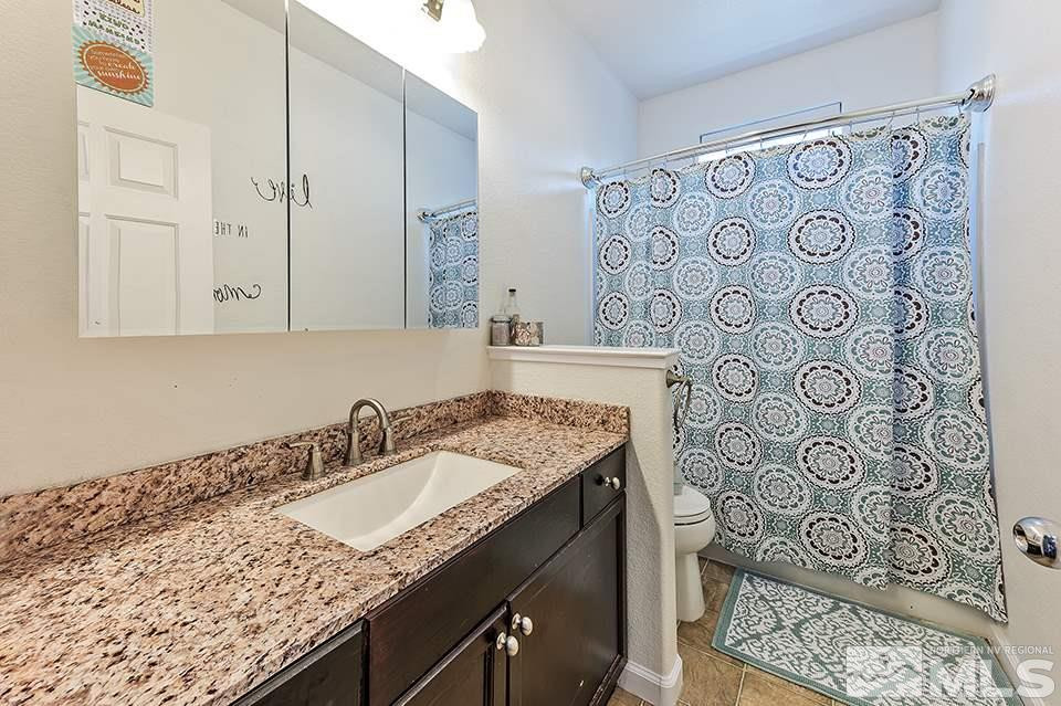 1783 Back Country Road Reno, NV 89521 - Photo 14 of 16 a bathroom with a granite countertop sink and a mirror