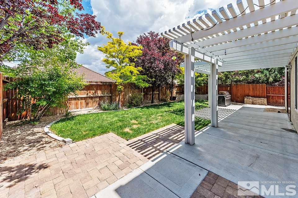 1783 Back Country Road Reno, NV 89521 - Photo 16 of 16 a view of a patio with a table and chairs next to a yard
