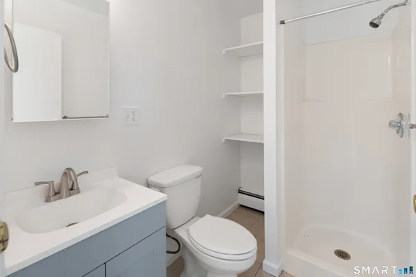 a white toilet sitting next to a bathroom sink