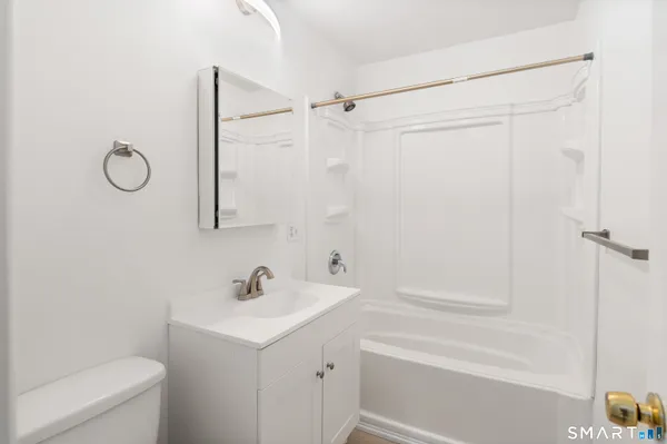 a bathroom with a sink a mirror and a shower