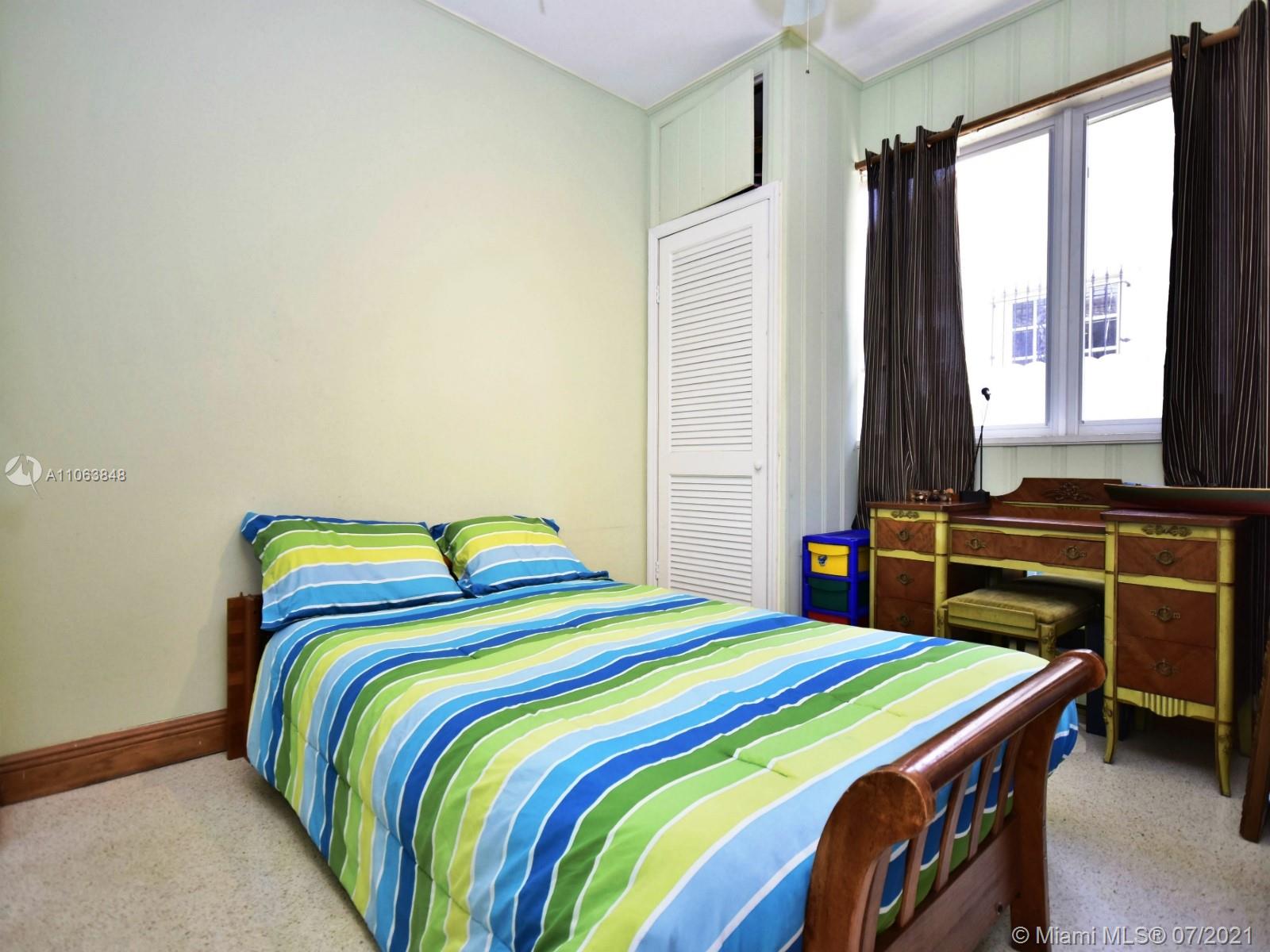 4755 Alton Road Miami Beach, FL 33140 - Photo 12 of 21 a bedroom with a bed and a window