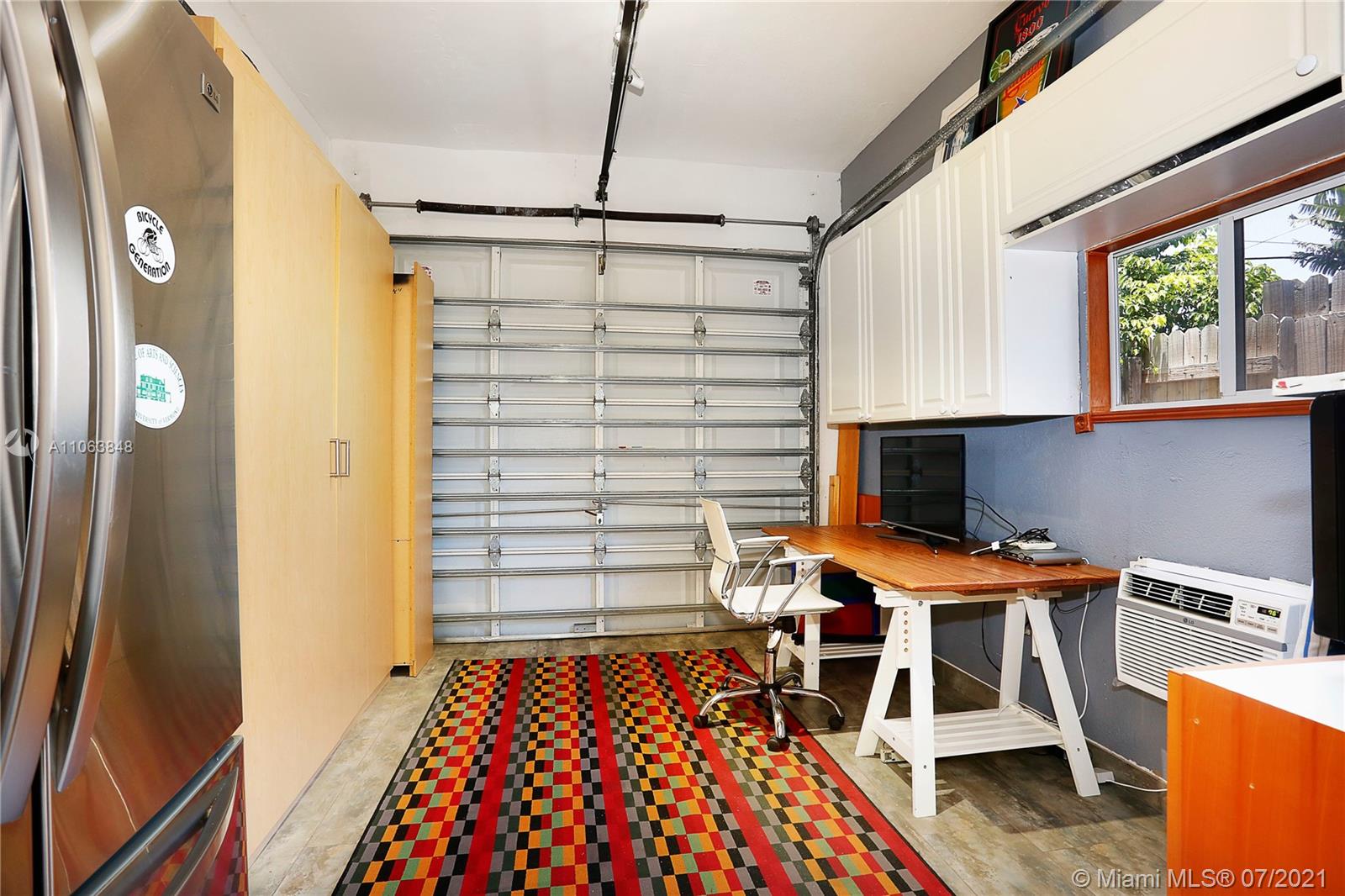 4755 Alton Road Miami Beach, FL 33140 - Photo 14 of 21 a room that has a bed and a table in it