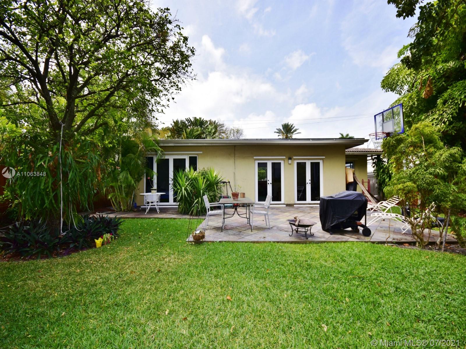 4755 Alton Road Miami Beach, FL 33140 - Photo 18 of 21 a view of a backyard with plants and lake view