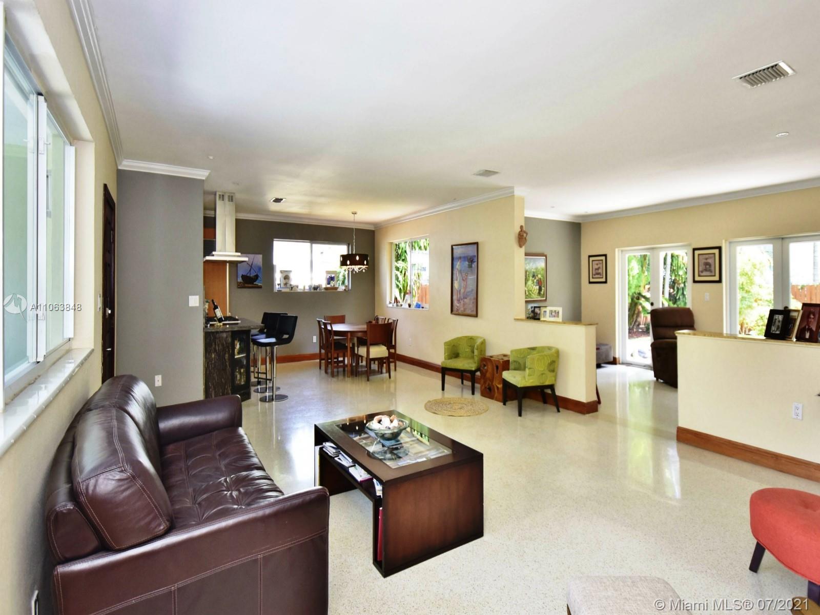 4755 Alton Road Miami Beach, FL 33140 - Photo 4 of 21 a living room with furniture and a large window