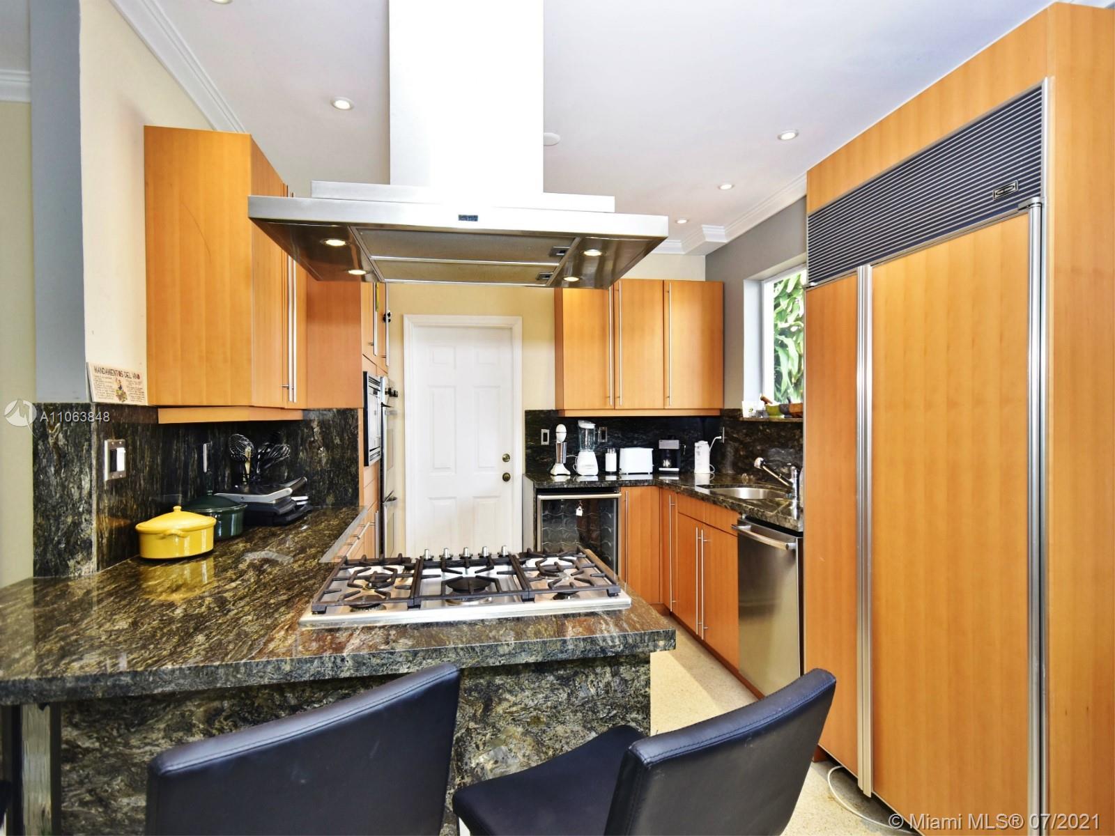 4755 Alton Road Miami Beach, FL 33140 - Photo 6 of 21 a kitchen with stainless steel appliances granite countertop a stove and a sink