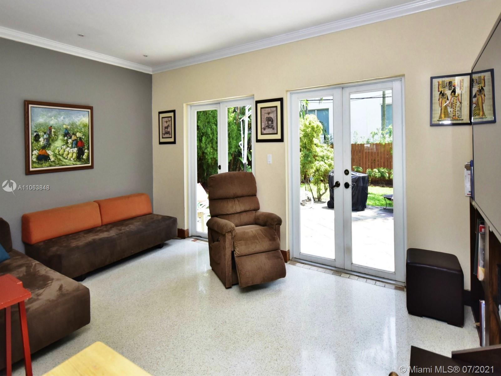 4755 Alton Road Miami Beach, FL 33140 - Photo 8 of 21 a living room with furniture and a potted plant