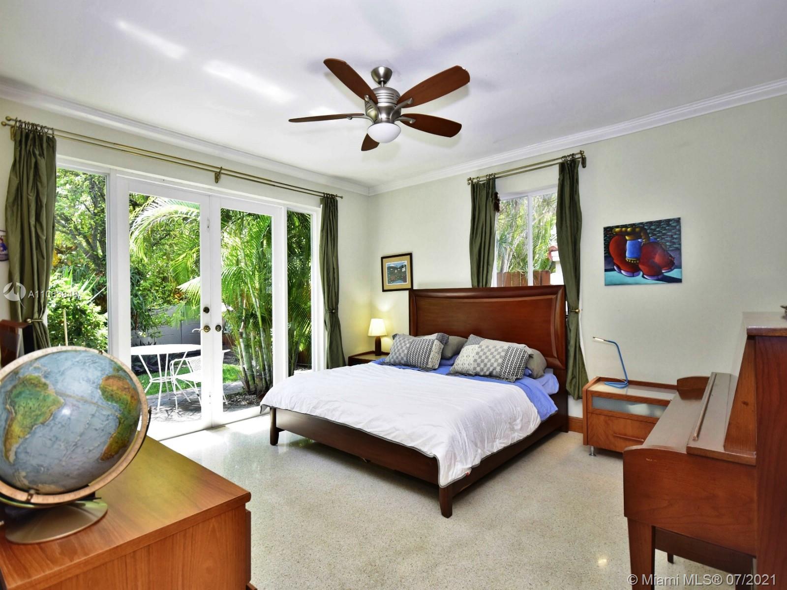 4755 Alton Road Miami Beach, FL 33140 - Photo 9 of 21 a bedroom with a bed and a large window