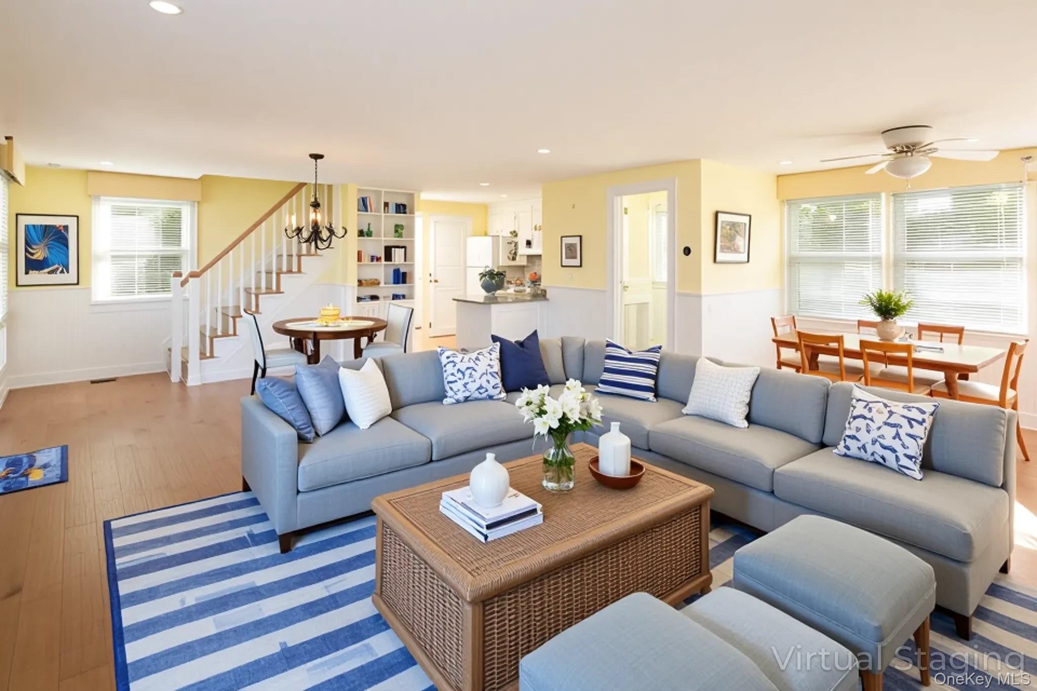 1 Canal Road Hampton Bays, NY 11946 - Photo 15 of 50 Living area featuring wood finished floors, healthy amount of natural light, recessed lighting, stairway, and a chandelier