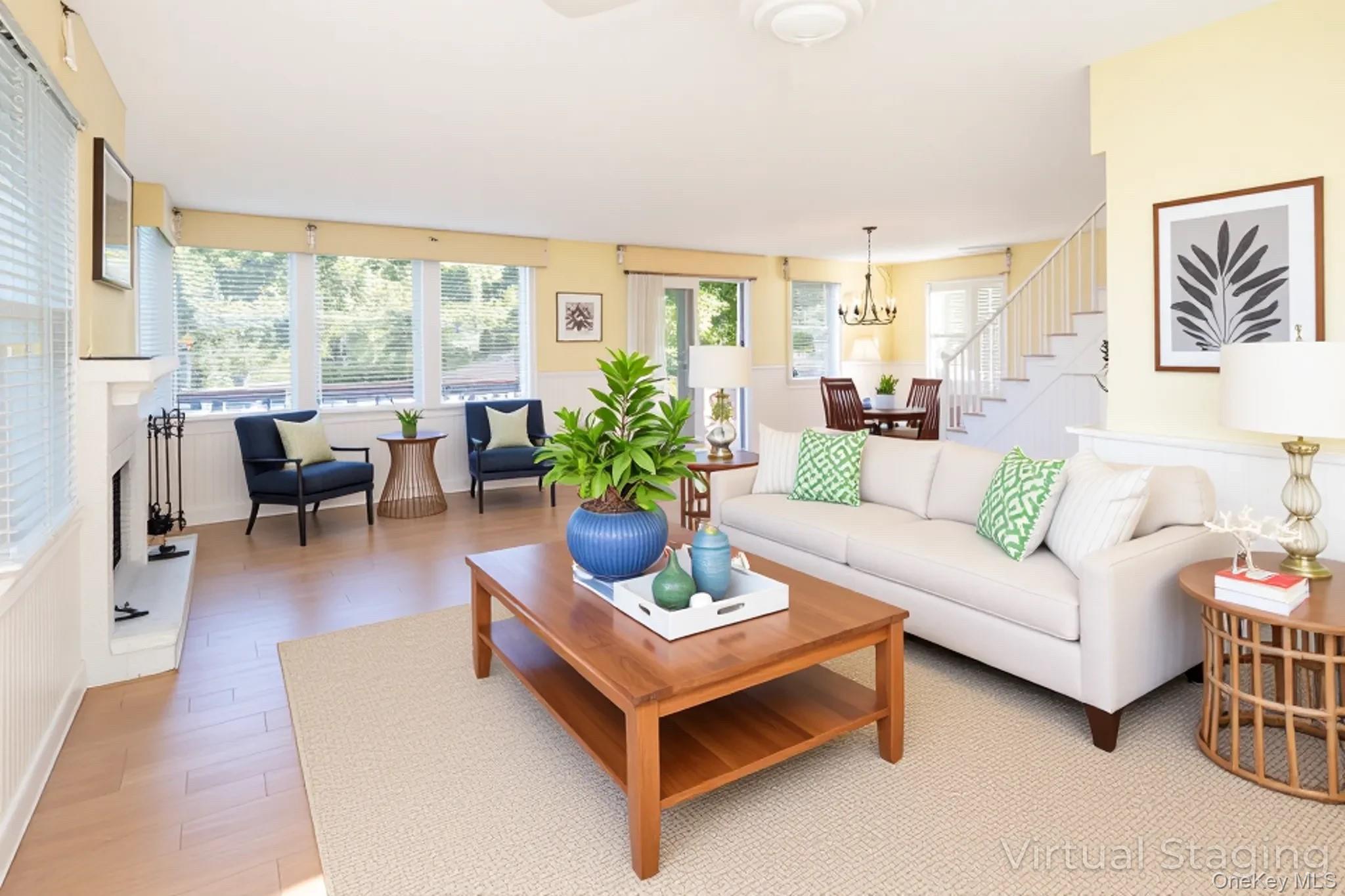 1 Canal Road Hampton Bays, NY 11946 - Photo 18 of 50 Virtually Staged Living area featuring light wood-style floors and a chandelier