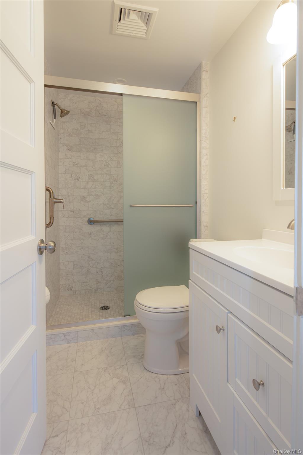1 Canal Road Hampton Bays, NY 11946 - Photo 29 of 50 Full bath featuring vanity, a stall shower, and light marble finish flooring
