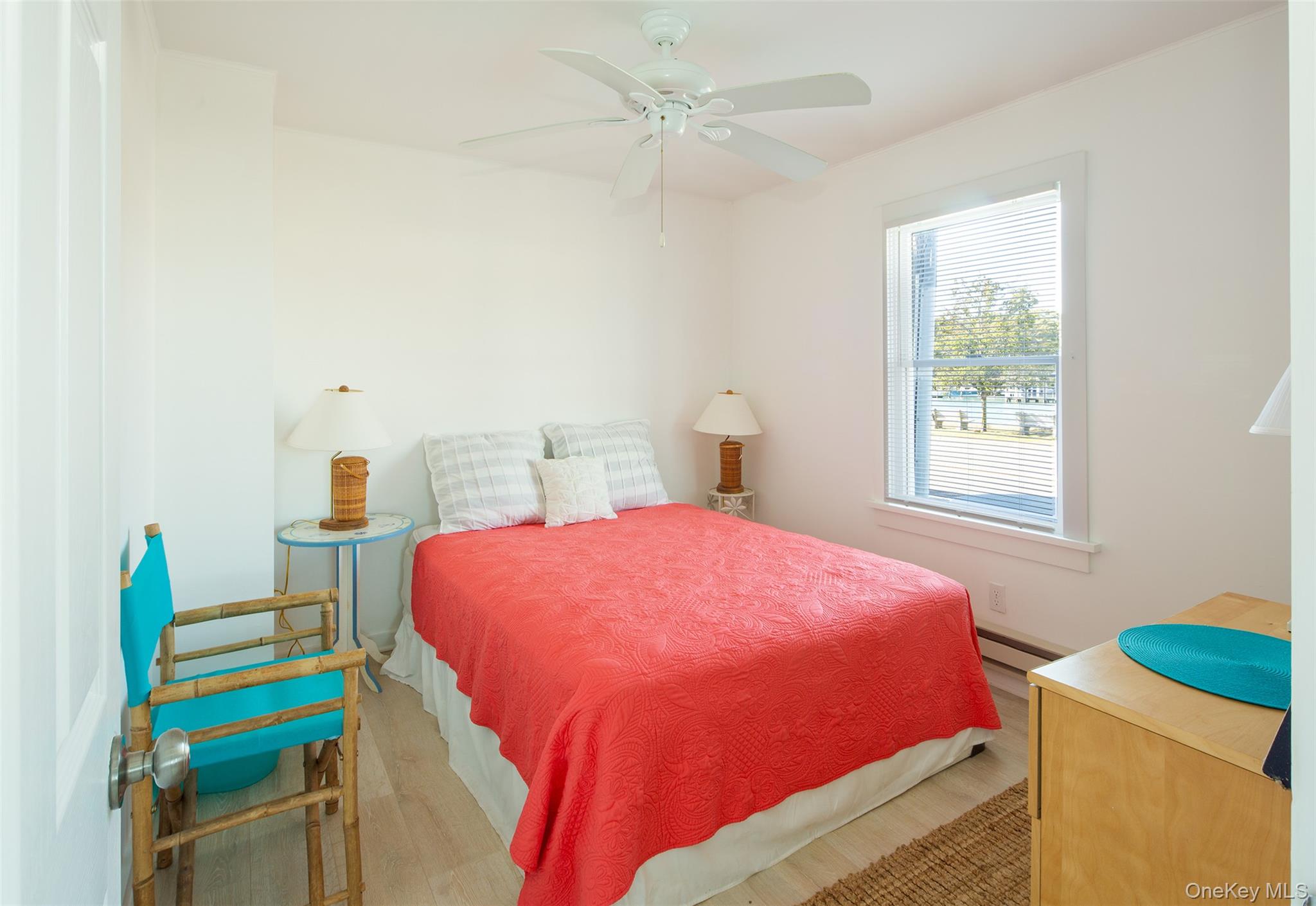 1 Canal Road Hampton Bays, NY 11946 - Photo 40 of 50 Bedroom with wood finished floors, a ceiling fan, and a baseboard heating unit
