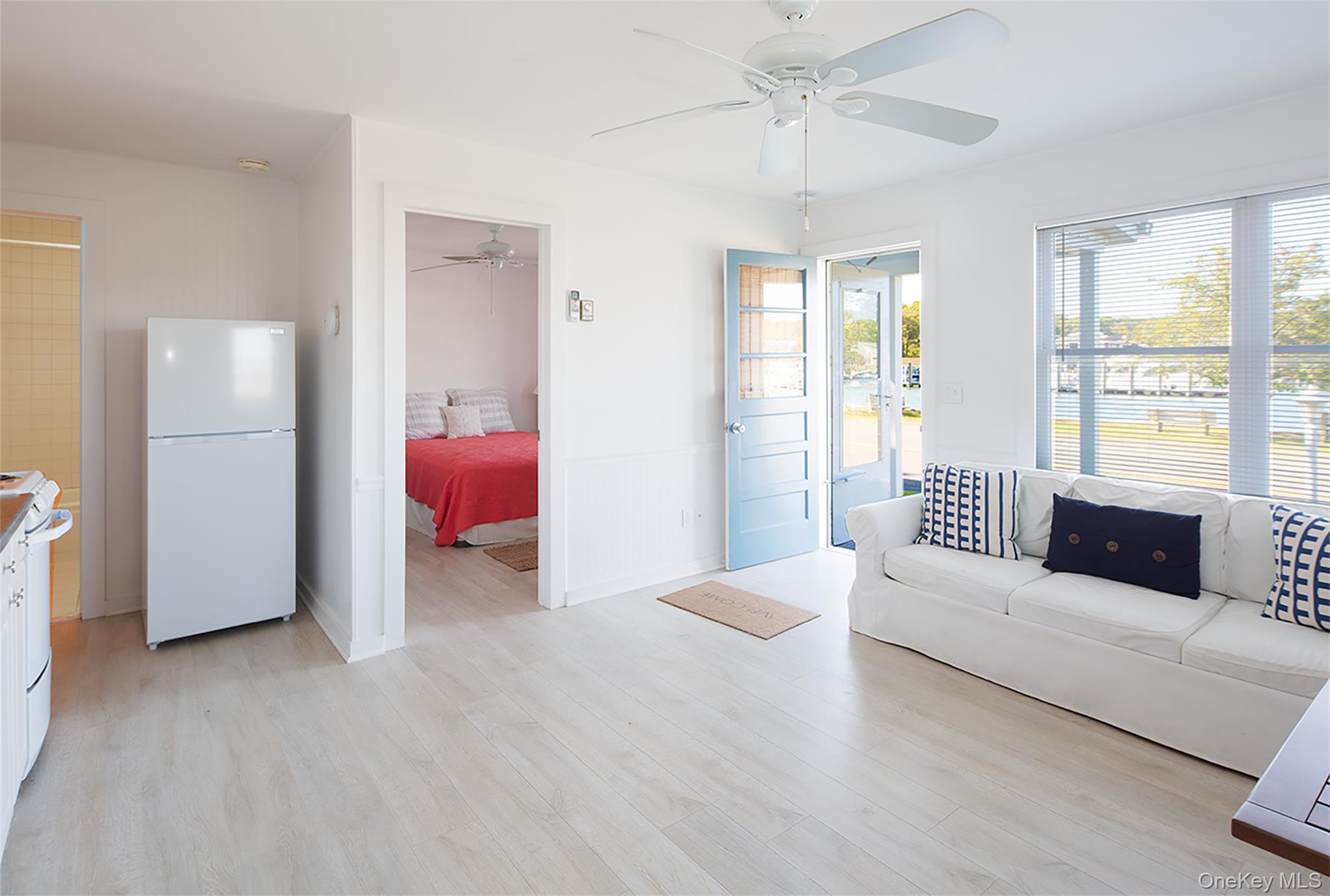 1 Canal Road Hampton Bays, NY 11946 - Photo 43 of 50 Living area with light wood finished floors and ceiling fan