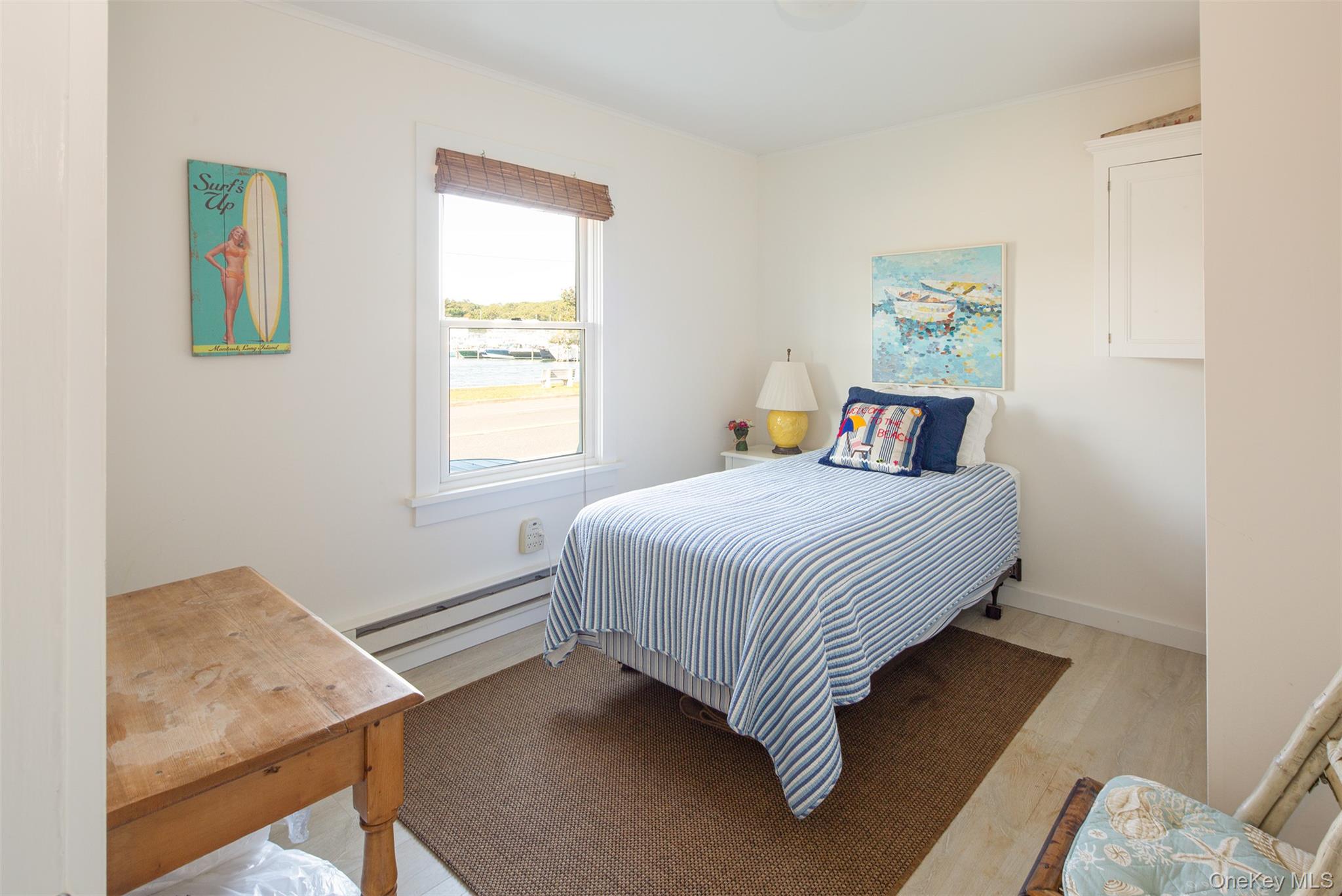 1 Canal Road Hampton Bays, NY 11946 - Photo 49 of 50 Bedroom with a baseboard heating unit and light wood finished floors