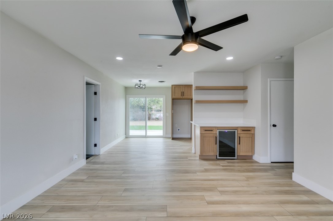 4036 Maple Hill Road Las Vegas, NV 89115 - Photo 14 of 43 An open living area showcases contemporary flooring and a sleek wet bar for effortless entertaining.