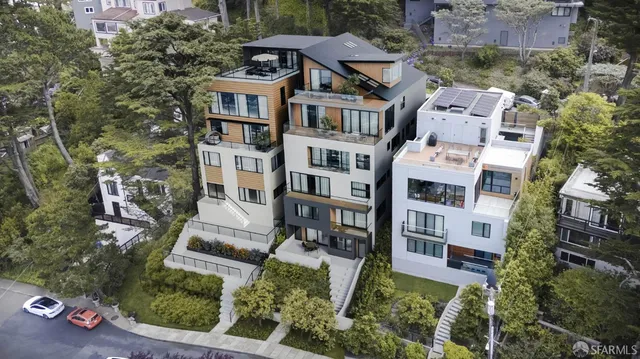 an aerial view of residential houses with outdoor space