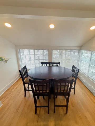 a view of a dining room with furniture and wooden floor