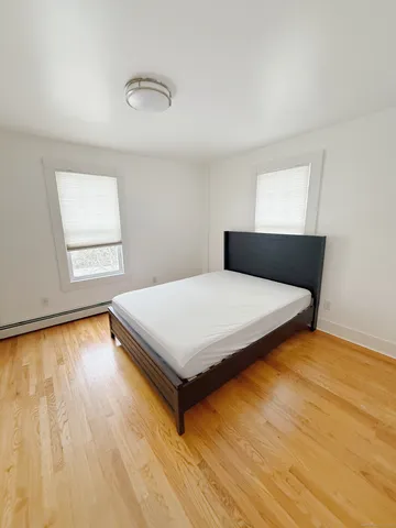 a bedroom with a bed and window