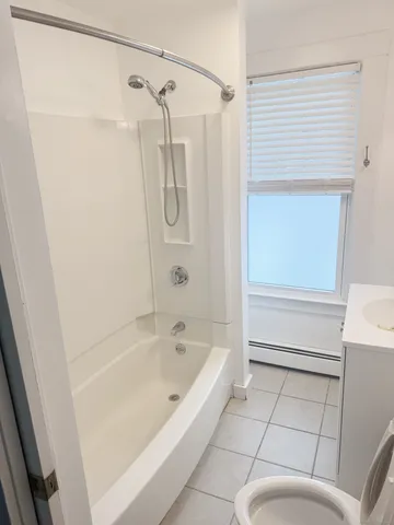 a bathroom with a bathtub and a shower
