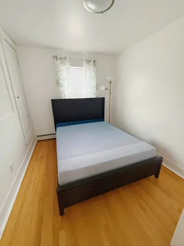 a bedroom with a bed and window