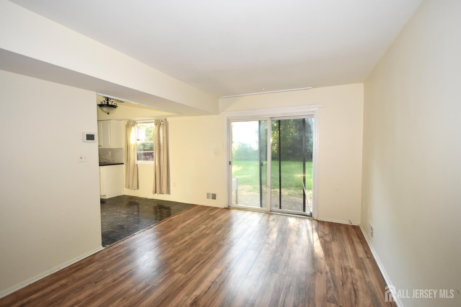 8 Wethersfield Road Plainsboro, NJ 08536 - Photo 13 of 28 wooden floor in an empty room with a window