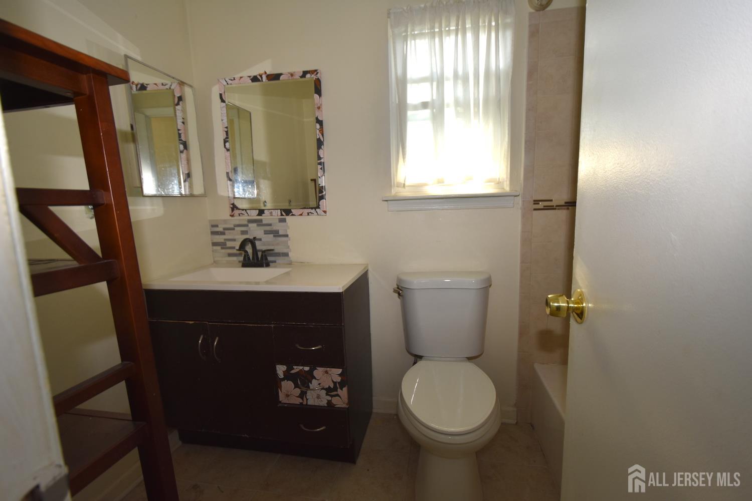 8 Wethersfield Road Plainsboro, NJ 08536 - Photo 20 of 28 a bathroom with a sink toilet and mirror