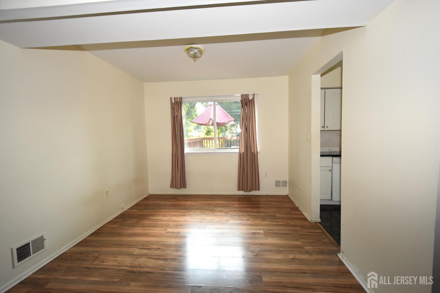 8 Wethersfield Road Plainsboro, NJ 08536 - Photo 6 of 28 a view of an empty room with wooden floor and a window