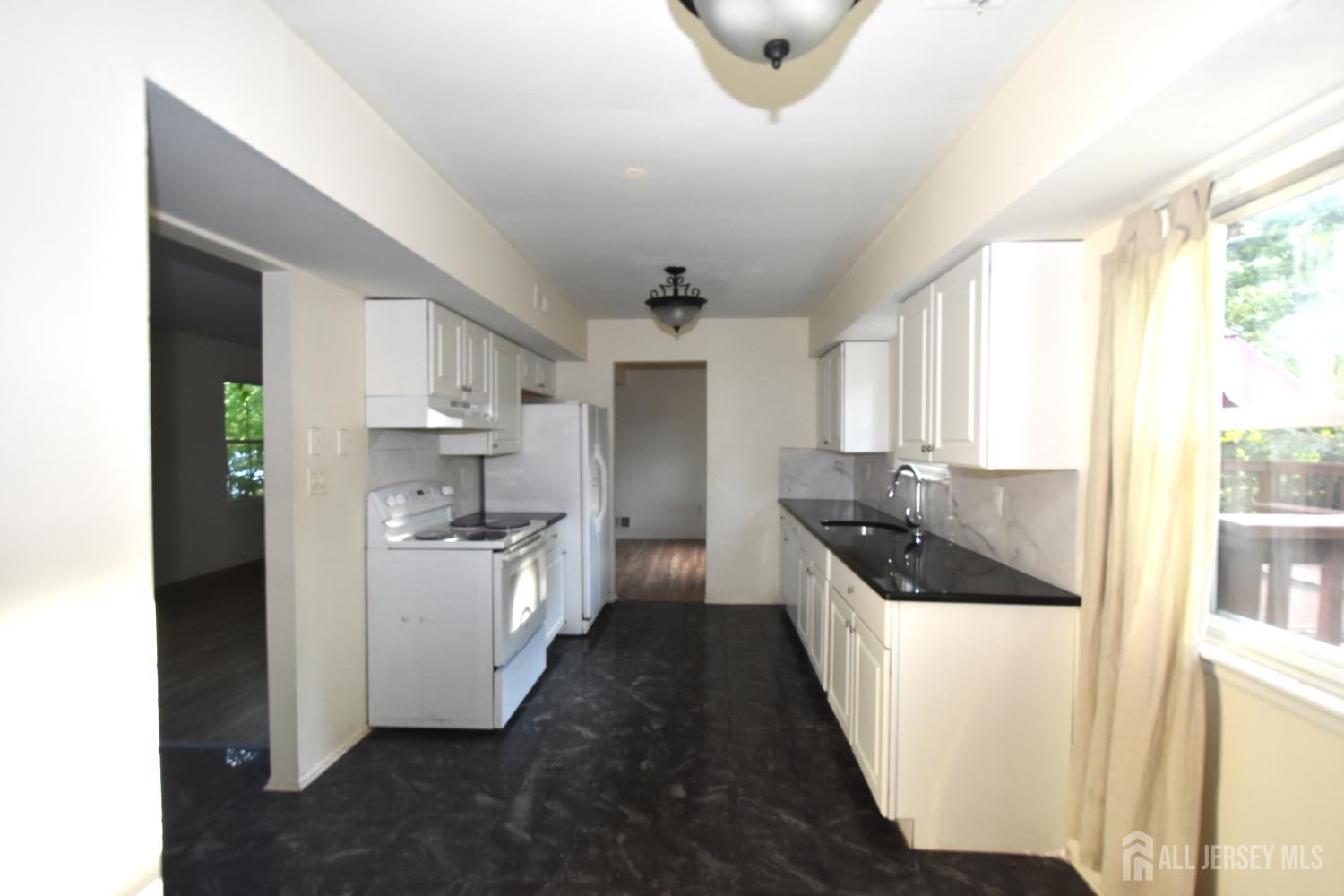 8 Wethersfield Road Plainsboro, NJ 08536 - Photo 8 of 28 a kitchen with a sink and refrigerator