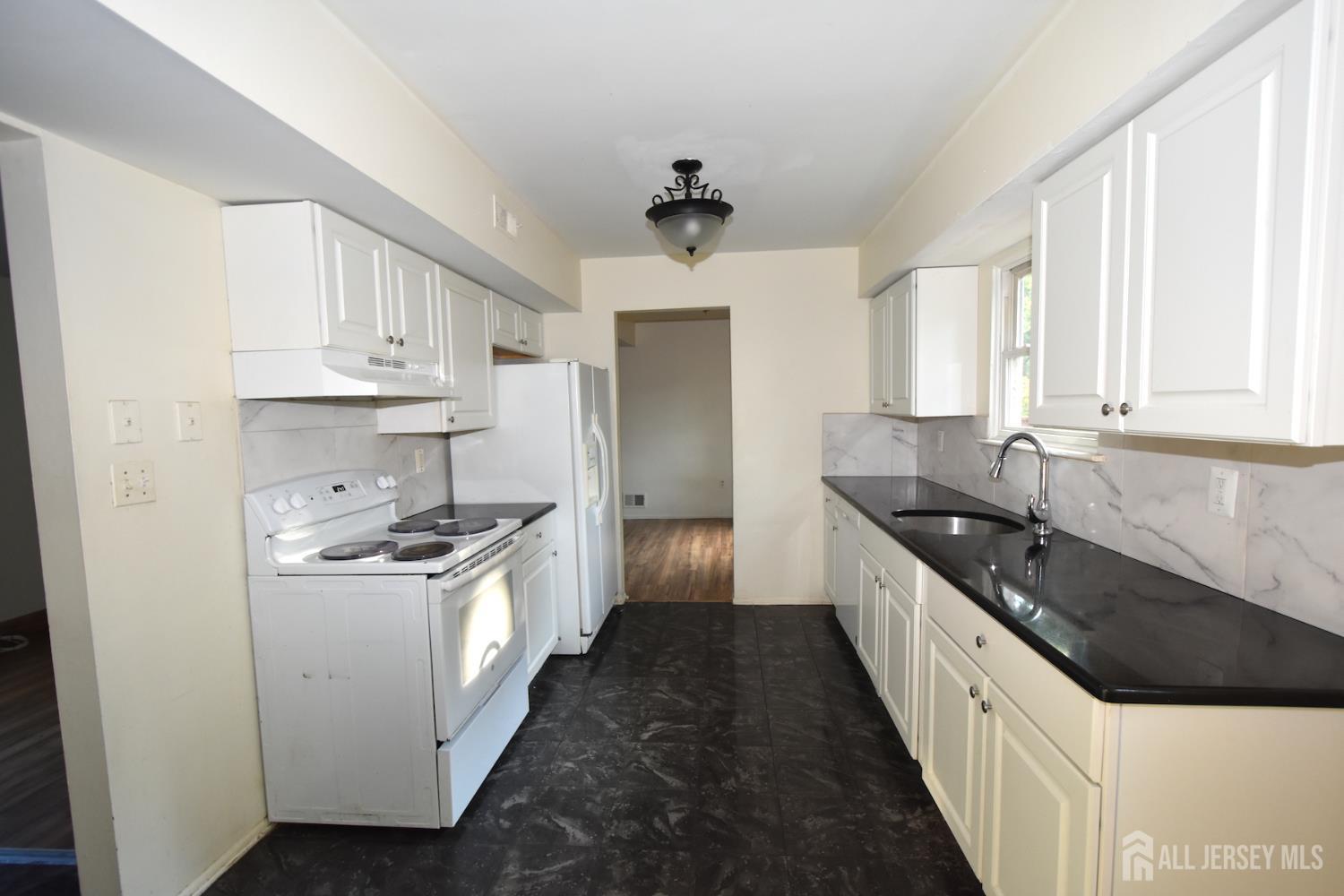 8 Wethersfield Road Plainsboro, NJ 08536 - Photo 9 of 28 a kitchen with stainless steel appliances a sink stove and cabinets