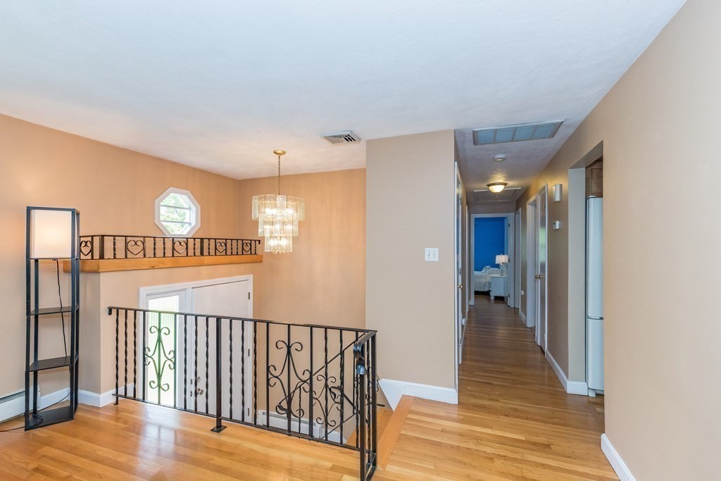 2 Marilyn Road Billerica, MA 01821 - Photo 12 of 32 a view of a hallway with wooden floor