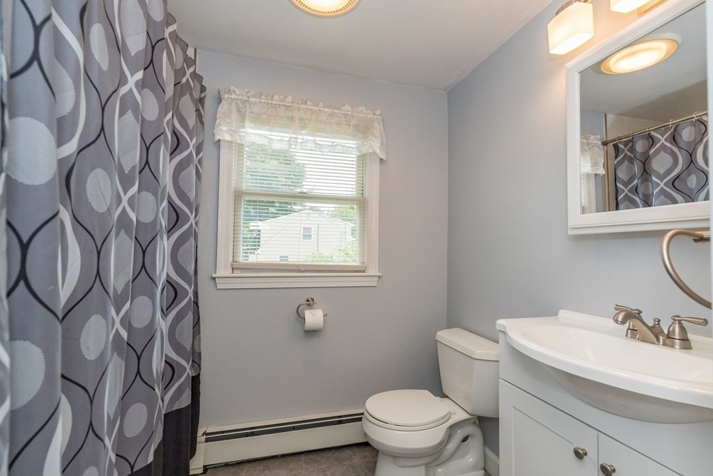2 Marilyn Road Billerica, MA 01821 - Photo 18 of 32 a bathroom with a toilet sink and mirror