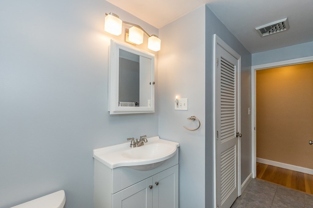 2 Marilyn Road Billerica, MA 01821 - Photo 19 of 32 a bathroom with a sink a toilet and mirror