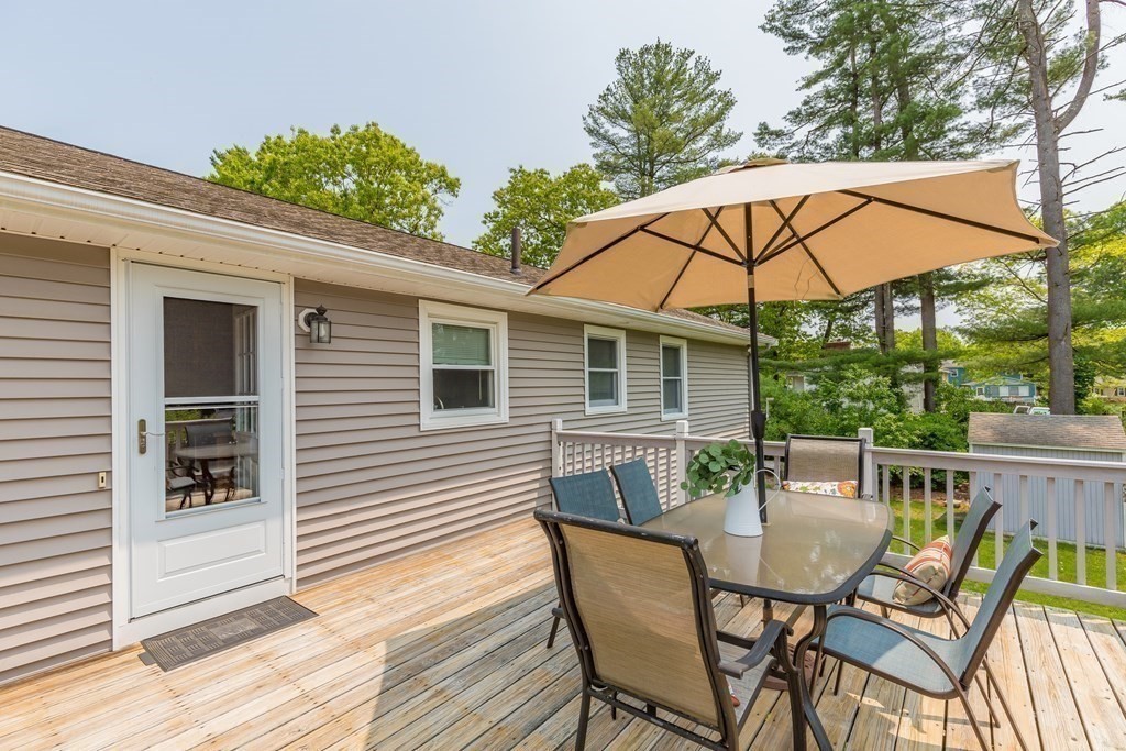 2 Marilyn Road Billerica, MA 01821 - Photo 29 of 32 a view of a patio with table and chairs under an umbrella