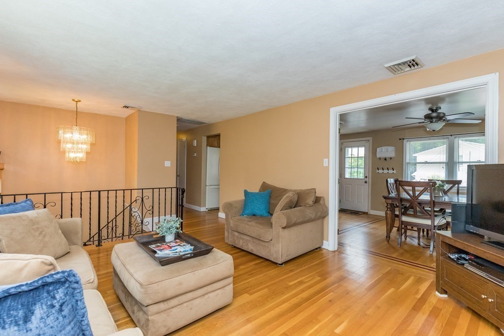 2 Marilyn Road Billerica, MA 01821 - Photo 4 of 32 a living room with furniture a rug and a flat screen tv